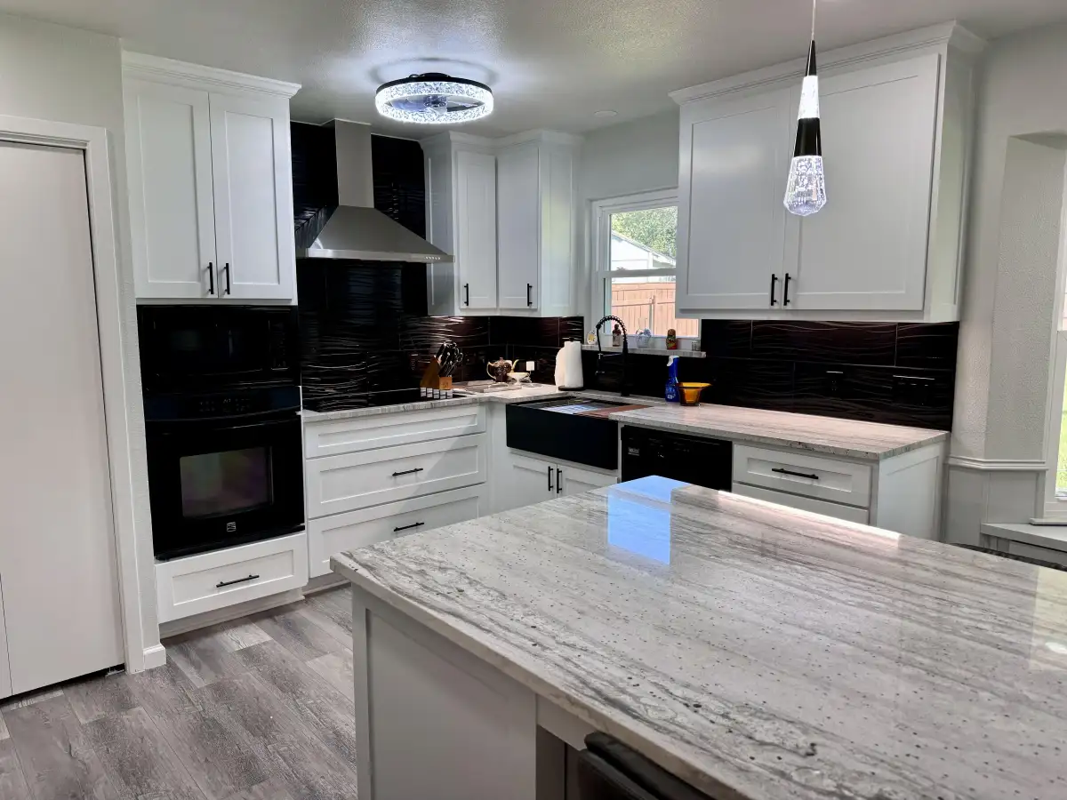 Kitchen with black wave tile backsplash installation